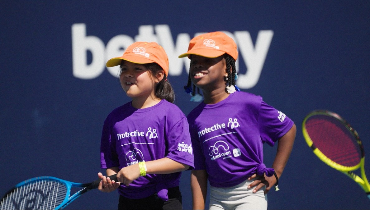 A video thumbnail of two children with tennis racquets wearing purple shirts with the Protective logo.
