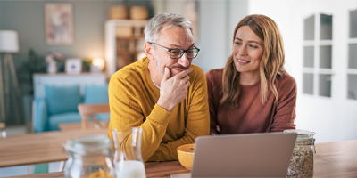 A man and his daughter looking at long term care benefits