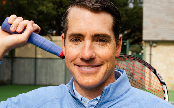 Brand Ambassador John Isner poses with racket.